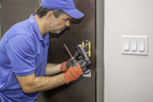 Locksmith disassembling a modern deadbolt lock